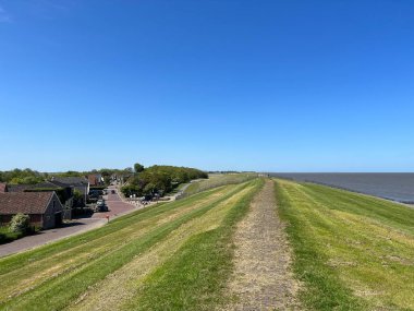Path on the dyke around Wierum in Friesland the Netherlands clipart