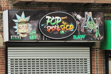 Bronx, NY - June 12, 2021: Pop Smoke Shop exterior in the Pelham Bay section of the Bronx. Urban legal marijuana dispensary with graffiti style sign 