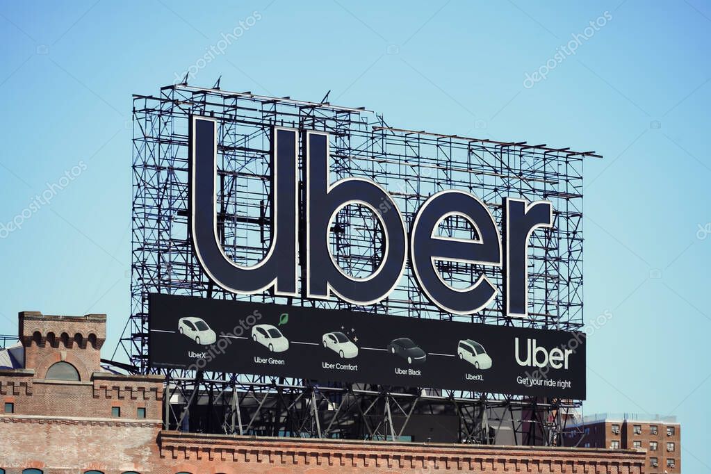 Manhattan, NY - April 9, 2023: New York City Uber car service billboard on top of building