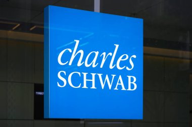 New York, NY - April 26, 2023 - Charles Schwab Corporation financial services company logo sign in window of Midtown Manhattan office clipart