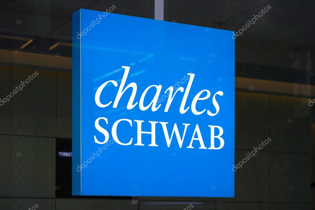 New York, NY - April 26, 2023 - Charles Schwab Corporation financial services company logo sign in window of Midtown Manhattan office