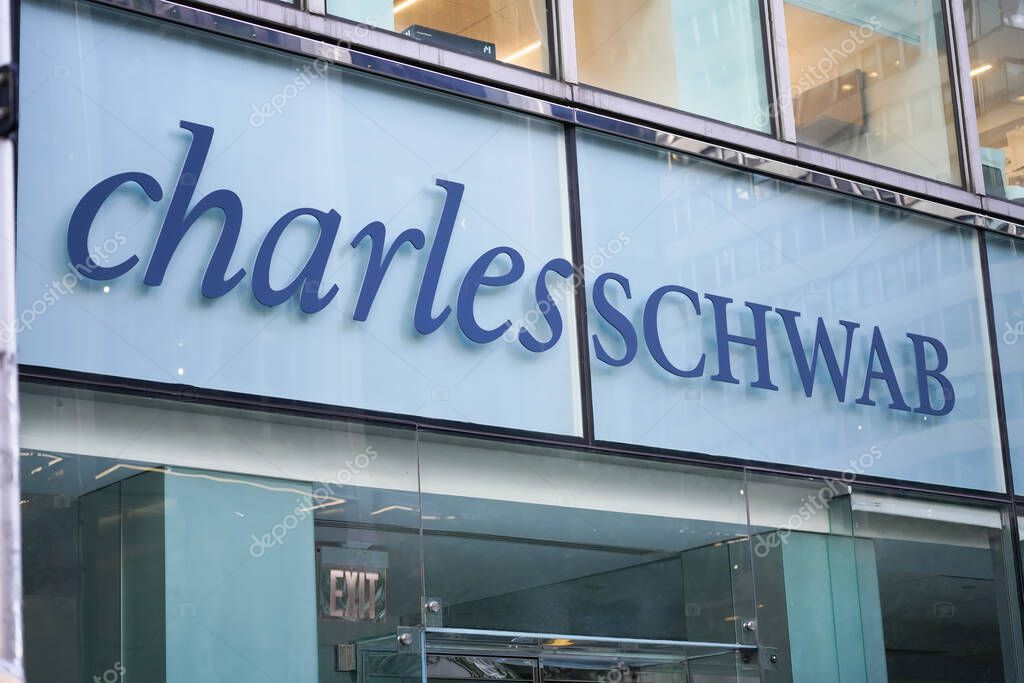 New York, NY - April 26, 2023 - Charles Schwab Corporation financial services company logo sign in window of Midtown Manhattan branch office