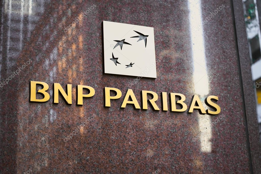 New York, NY - November 23, 2023:Bnp Paribas French multinational bank logo sign  on USA corporate headquarters office building polished marble wall reflecting skyscrapers in Midtown, Manhattan