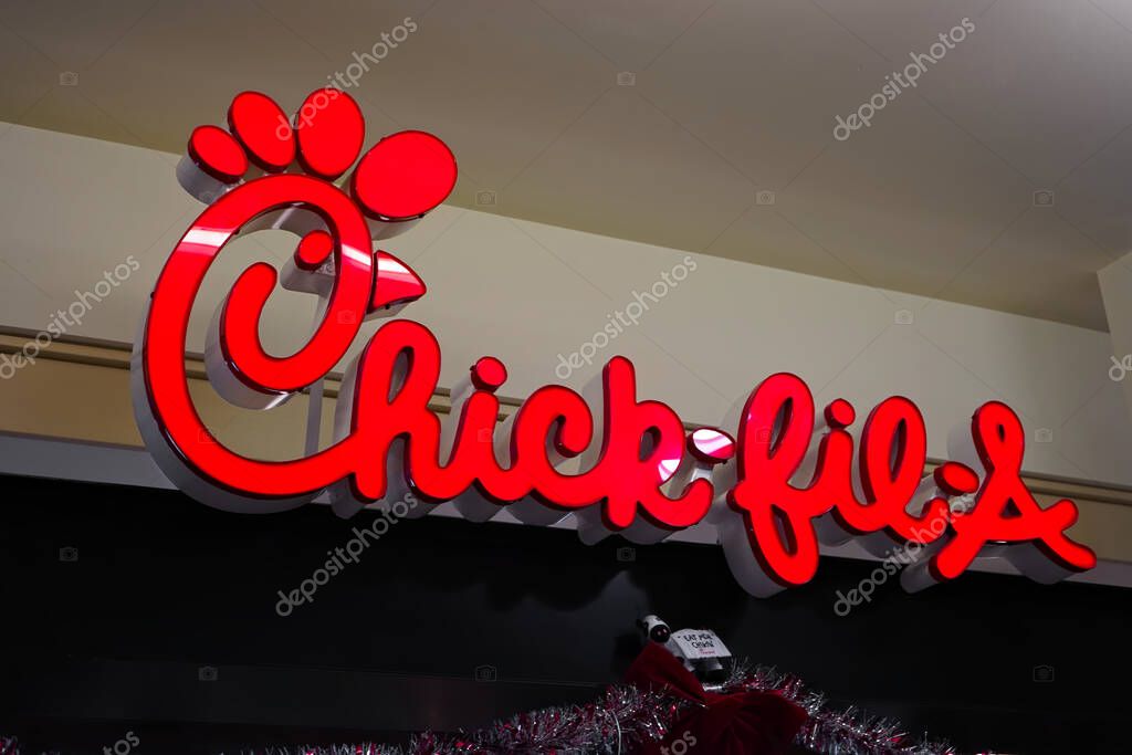 Honolulu, Hawaii - December 23, 2023: Chick-fil-A fast food restaurant chain logo sign closeup in Ala Moana shopping mall food court.