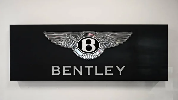 stock image Honolulu, Hawaii - Jan. 12, 2024: Bentley Motors wall insignia on luxury auto dealer office wall.