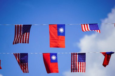 Photograph of rows of United States and Taiwanese flags hanging in the sky showing partnership. Taiwan is a world leader in semiconductor manufacturing clipart