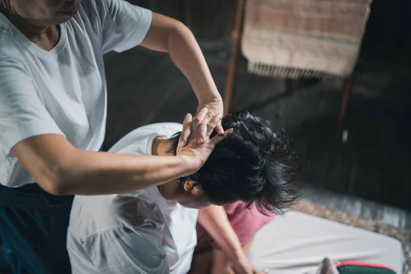 Massage and spa relaxing treatment of office syndrome traditional thai massage style. Asain senior female masseuse doing massage treat head, back pain, arm pain, foot and stress for old woman tired.