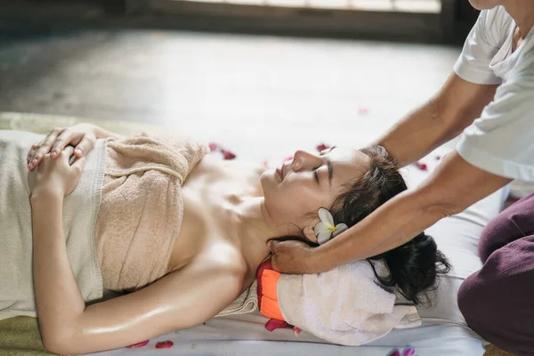 Massage and spa relaxing treatment of office syndrome traditional thai massage style. Asain female masseuse doing massage treat back pain, arm pain and stress for office woman tired from work.
