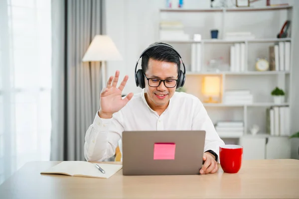 Asian Freelance Business Man Wearing Headphones Making Video Call Home — Stock Photo, Image