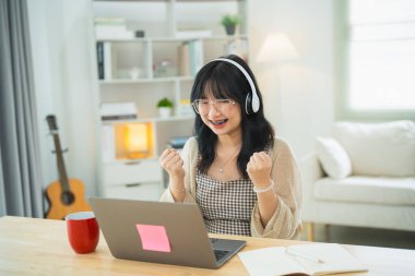Gözlüklü, beyaz kulaklık takan, başarılı bir iş adamı olan serbest girişimci kadın bilgisayarda ve merkez ofisteki masa başında klavye çalıyor. İş teknolojisi.