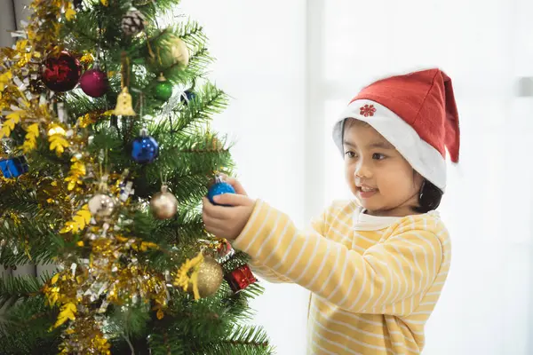 Children Kids Girl Hanging Small Glitter Ball Decorating Christmas Tree Royalty Free Stock Images