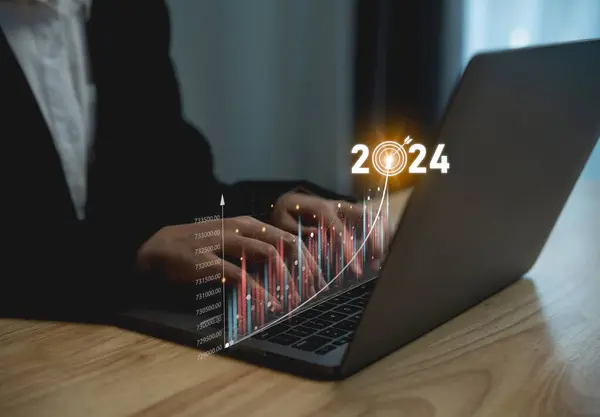 2024 business target goal finance technology and investment stock market trading concept. businesswoman using laptop virtual graph icon analyzing forex or crypto currency trading graph financial data.