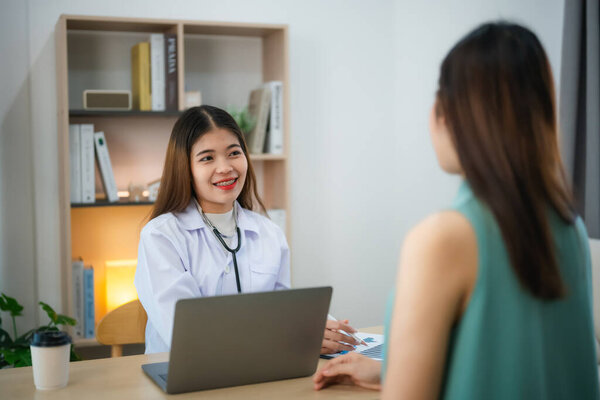 Asian professional woman doctor talking consult for healthcare solution to her patient or pregnant woman in examination room at hospital or clinic.