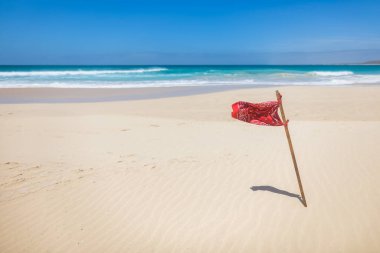 Red flag due to strong waves on Santa Monica beach on Boa Vista island clipart