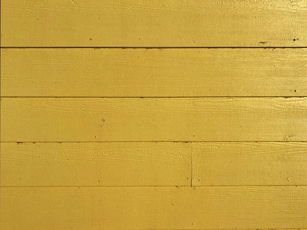a yellow painted wooden board fence home wood building house cabin wall exterior design