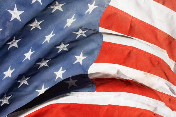 a worn old vintage American flag patriotic backdrop America symbol faded background