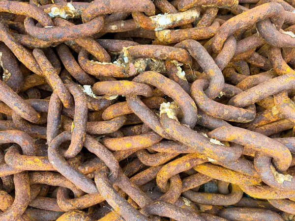 a dock anchor iron chain metal rusty chained voyage lock safety weight port anchored closeup rusted connection steel cruise marine vessel ship sailing navy link rough strong oxidized vintage nautical