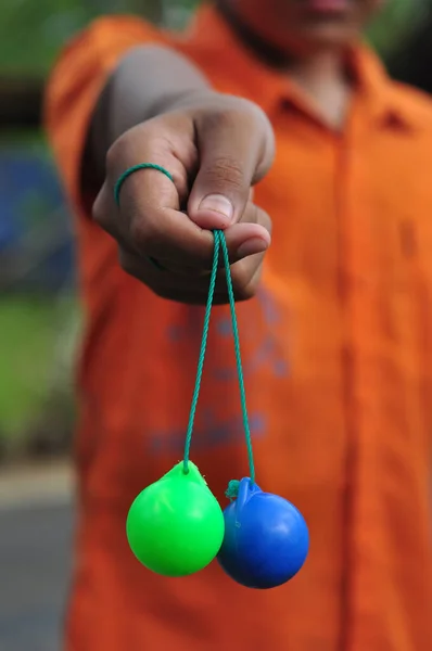 stock image An Indonesian child who is not recognized is playing lato-lato