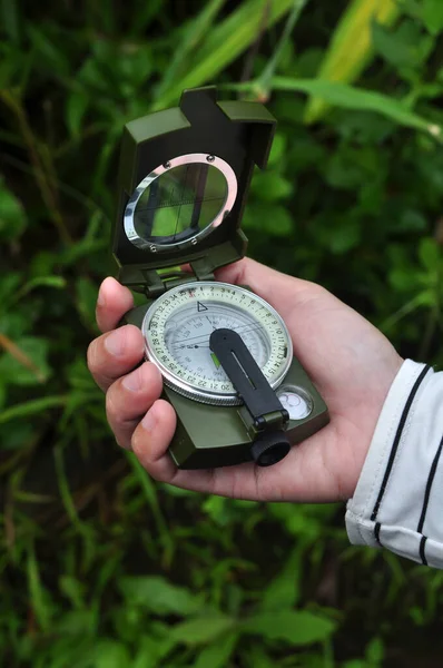 stock image Holding outdoor adventure navigation compass selective focus