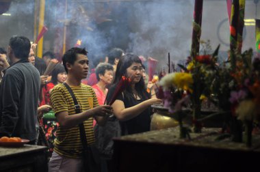 Jakarta, Indonesia - February 19, 2015 : Chinese residents are carrying out Chinese New Year worship at Vihara Dharma, Glodok, Jakarta - Indonesia clipart