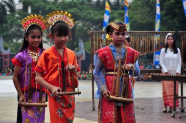 Jakarta, Indonesia - April 19, 2015 : Appearances from various tribes in Indonesia at the Culture Carnival event at TMII, Jakarta - Indonesia clipart