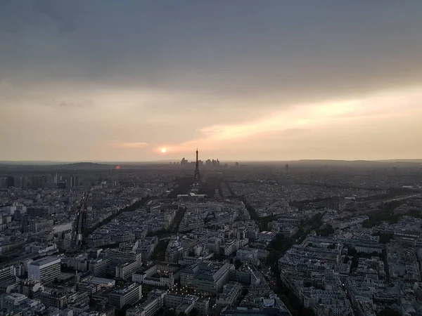 Paris panorama from above with Eiffel Tower and La Defense skyscrapers on the background at sunset time