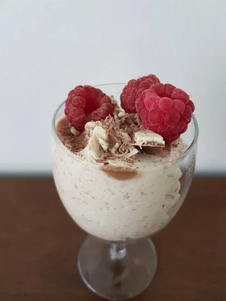 Self-made chocolate cheesecake with raspberries in a glass