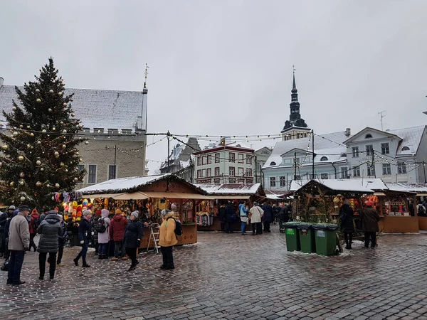 People, Christmas market stalls and a Christmas tree in Tallinn, Estonia