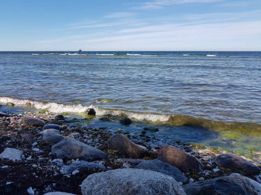 Rocks and waves at sea shore on a summer day in Visby, Sweden