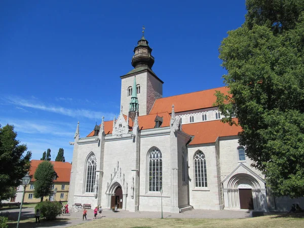 People outside Visby Cathedral in Gotland, Sweden