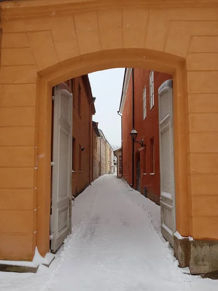 Doorway to a colorful alley at winter with snow on ground in Turku, Finland