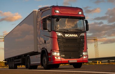 Scania S 730 truck with semi-trailer on the motorway clipart