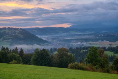 Beautiful, misty sunrise over a mountain village in the Carpathian Mountains.Poland clipart