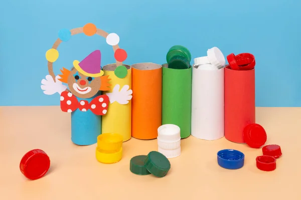 DIY, clown handicraft from recycled materials, stand for school items made from empty rolls of toilet paper, learn colors with bottle caps