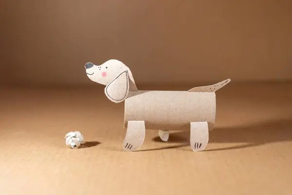 a dog made out of toilet paper roll, cut out of cardboard, dachshund, kids toy, recycled paper craft concept, DIY, activity for kids