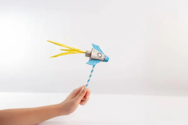 hand hold paper rockets craft, fun toy making project for kids, DIY, straw, white background