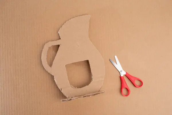 stock image Crafting essentials: paper pitcher cutout, scissors, and cardboard pieces