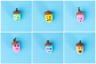 Farklı renkler ve yüzlerle boyanmış palamutlar, açık mavi arka planda ızgara, garip karakterler, sonbahar sanatı, yaratıcı doğa sanatı, DIY projesi