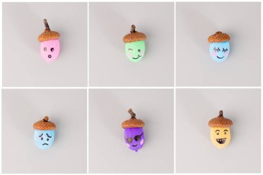 El yapımı meşe palamutları ve açık gri bir arkaplan üzerinde düzenlenmiş çeşitli yüz ifadeleri. DIY ve el işi projeleri için. Sonbahar ve mevsimlik dekorasyon kavramı. 