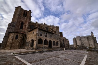 Castle of Santa Ana in Castro Urdiales. Cobblestone enclosure, , moving and escaping clouds, tree, sunset, sunny, buildings