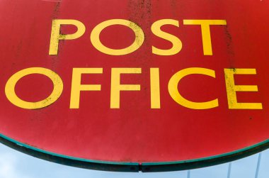 COTTENHAM, ENGLAND, UK - DECEMBER 30, 2013: Symbol of an English Post Office in the village of Cottenham, Cambridgeshire, England, UK