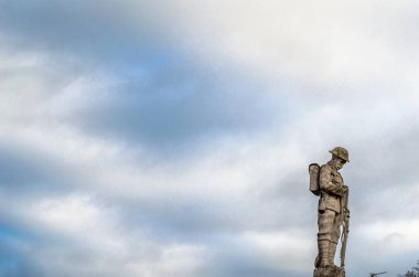 COTTENHAM, ENGLAND, UK - DECEMBER 30, 2013: Statue in the village of Cottenham, Cambridgeshire, England, UK, dedicated to the memory of the men of Cottenham who died in World War I and World War II