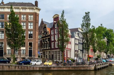 AMSTERDAM, THE NETHERLANDS - AUGUST 24, 2013: Urban landscape in Amsterdam, the Netherlands, view of streets and canals in the famous Canal District, designated as a UNESCO World Heritage Site