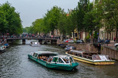 AMSTERDAM, THE NETHERLANDS - AUGUST 24, 2013: Urban landscape in Amsterdam, the Netherlands, view of streets and canals in the famous Canal District, designated as a UNESCO World Heritage Site