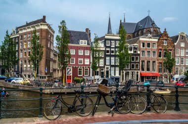AMSTERDAM, THE NETHERLANDS - AUGUST 24, 2013: Urban landscape in Amsterdam, the Netherlands, view of streets and canals in the famous Canal District, designated as a UNESCO World Heritage Site