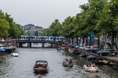 AMSTERDAM, THE NETHERLANDS - AUGUST 24, 2013: Urban landscape in Amsterdam, the Netherlands, view of streets and canals in the famous Canal District, designated as a UNESCO World Heritage Site