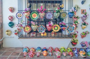 MIJAS, SPAIN - OCTOBER 9, 2021: Souvenir and handicraft shop, with ceramics and other typical products in the village of Mijas on the Costa del Sol, Malaga province, Andalusia, southern Spain