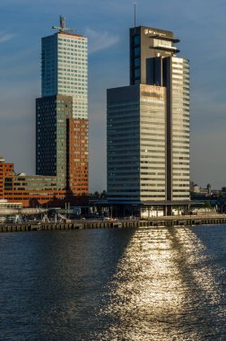 ROTTERDAM, THE NETHERLANDS - AUGUST 26, 2013: Urban landscape, view of skyscrapers standing close to the river Meuse, at Kop van Zuid neighborhood in Rotterdam, the Netherlands