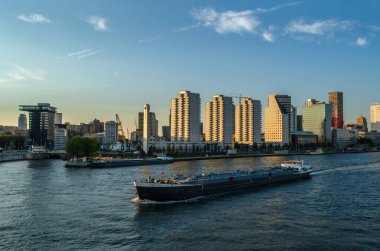 ROTTERDAM, THE NETHERLANDS - AUGUST 26, 2013: Urban landscape, view of skyscrapers standing close to the river Meuse, at Kop van Zuid neighborhood in Rotterdam, the Netherlands