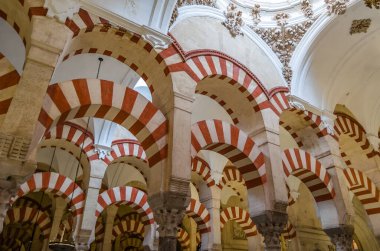 CORDOBA, SPAIN - FEBRUARY 15, 2014: Columns and double-tiered arches in the interior of the Mosque-Cathedral of Cordoba, Andalusia, southern Spain clipart